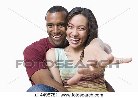 Studio portrait of young couple View Large Photo Image Stock Image - Studio portrait of young couple. Fotosearch