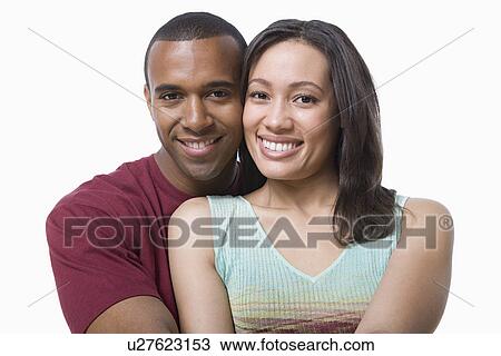 Studio portrait of young couple embracing View Large Photo Image Stock Image - Studio portrait of young couple embracing. Fotosearch