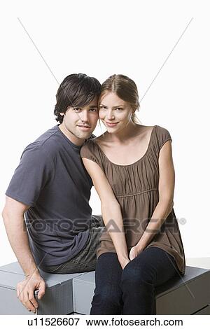 Stock Photo - Studio portrait of young couple. Fotosearch