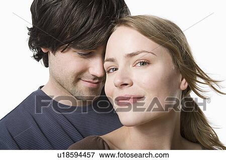 Studio portrait of young couple View Large Photo Image Stock Photo - Studio portrait of young couple. Fotosearch