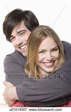 Studio portrait of young couple View Large Photo Image Stock Photo - Studio portrait of young couple. Fotosearch