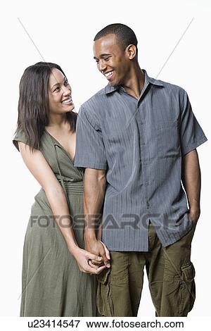 Stock Photo - Studio portrait of young couple. Fotosearch