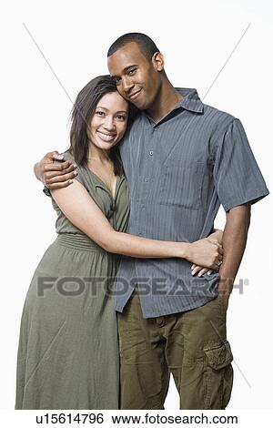 Stock Photograph - Studio portrait of young couple. Fotosearch