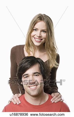 Studio portrait of young couple View Large Photo Image Stock Photograph - Studio portrait of young couple. Fotosearch