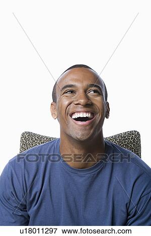 Studio portrait of young man laughing View Large Photo Image Stock Photo - Studio portrait of young man laughing. Fotosearch