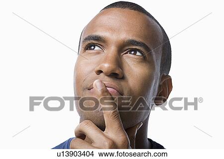 Studio portrait of young man contemplating View Large Photo Image Picture - Studio portrait of young man contemplating. Fotosearch