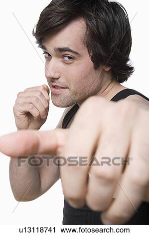 Studio portrait of young man punching air View Large Photo Image Stock Image - Studio portrait of young man punching air. Fotosearch