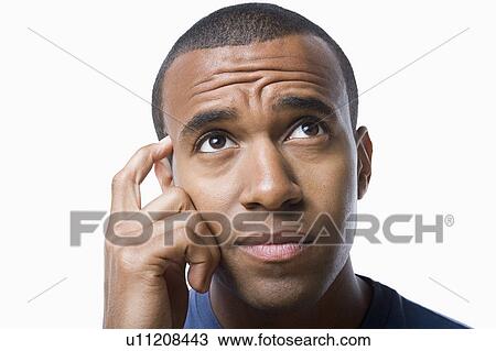 Studio portrait of young man contemplating View Large Photo Image Stock Image - Studio portrait of young man contemplating. Fotosearch