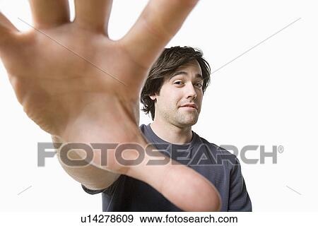 Stock Photo - Studio portrait of young man. Fotosearch