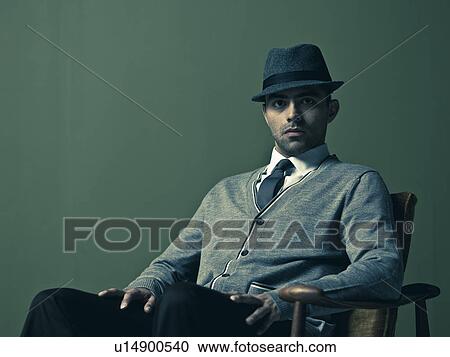Studio portrait of young man wearing hat View Large Photo Image Stock Image - Studio portrait of young man wearing hat. Fotosearch