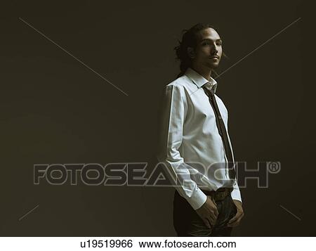Stock Photograph - Studio portrait of young man wearing shirt and tie. Fotosearch