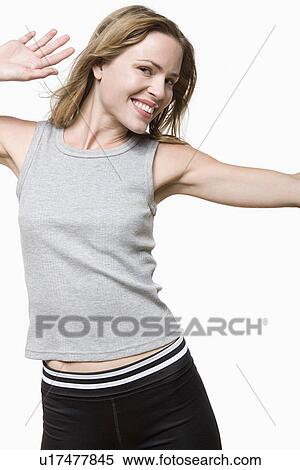 Stock Photography - Studio portrait of young woman dancing. Fotosearch