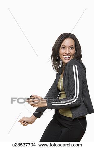 Studio portrait of young woman listening music View Large Photo Image Picture - Studio portrait of young woman listening music. Fotosearch