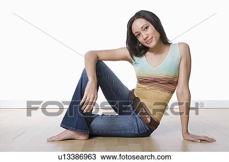 Stock Image - Studio portrait of young woman. Fotosearch