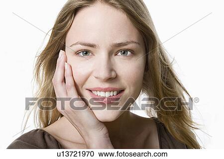 Stock Image - Studio portrait of young woman. Fotosearch