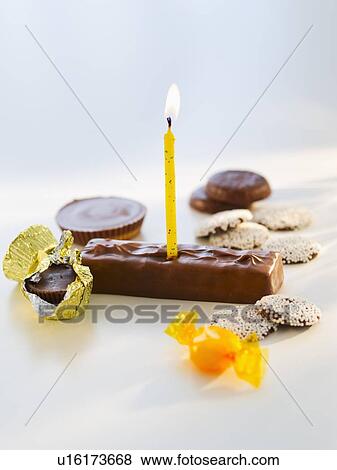Studio shot of chocolate bars with birthday candle View Large Photo Image Stock Photo - Studio shot of chocolate bars with birthday candle. Fotosearch