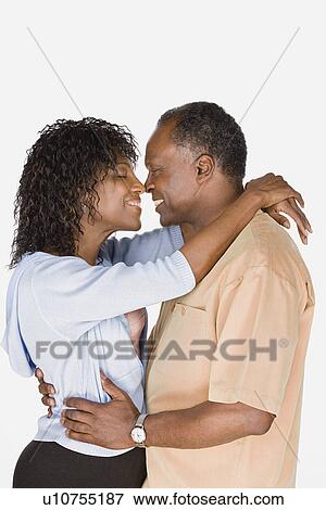 Studio shot of mature couple kissing View Large Photo Image Stock Photo - Studio shot of mature couple kissing. Fotosearch