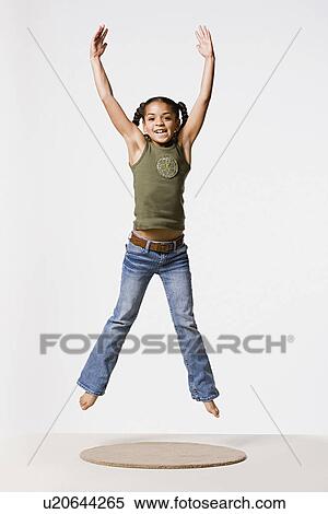 Studio shot of smiling girl (8-9) jumping, studio shot View Large Photo Image Stock Photography - Studio shot of smiling girl (8-9) jumping, studio shot. Fotosearch