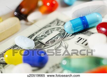 Stock Photography - Studio shot of various pills and capsules on one dollar bill. Fotosearch