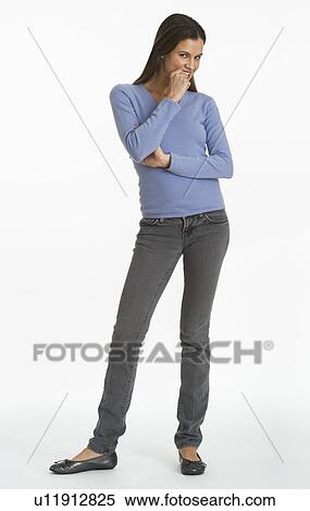 Studio shot of woman biting finger View Large Photo Image Stock Photography - Studio shot of woman biting finger. Fotosearch