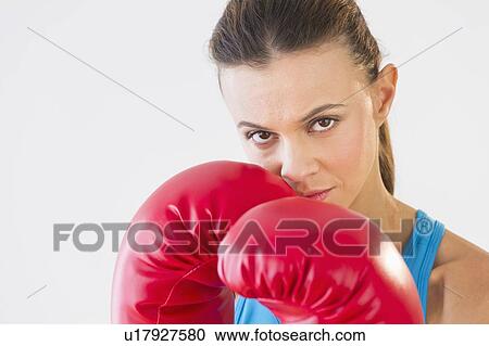 Stock Image - Studio shot of woman boxing. Fotosearch