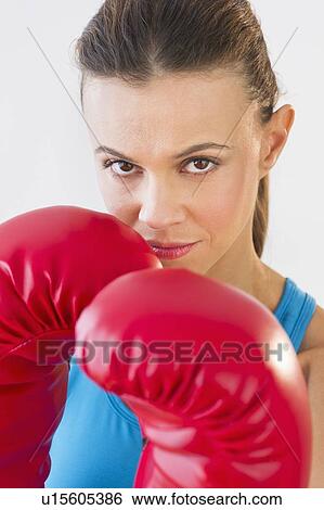 Stock Photograph - Studio shot of woman boxing. Fotosearch
