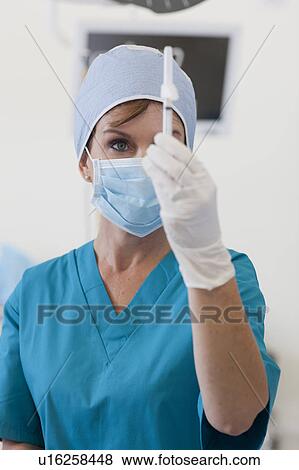 Stock Photo - Surgeon preparing injection. Fotosearch
