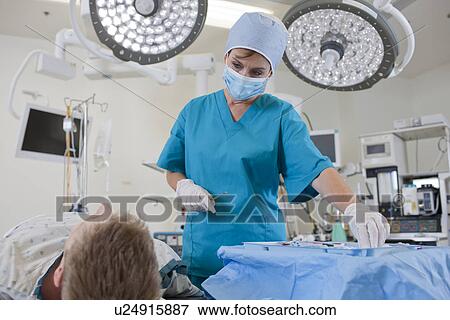 Surgeon preparing patient for surgery View Large Photo Image Stock Photo - Surgeon preparing patient for surgery. Fotosearch