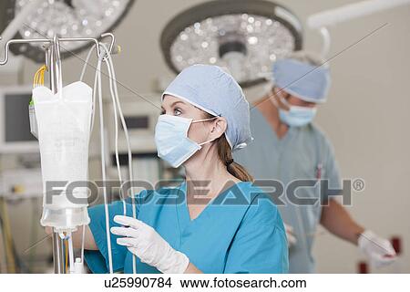 Picture - Surgeons getting ready for surgery. Fotosearch