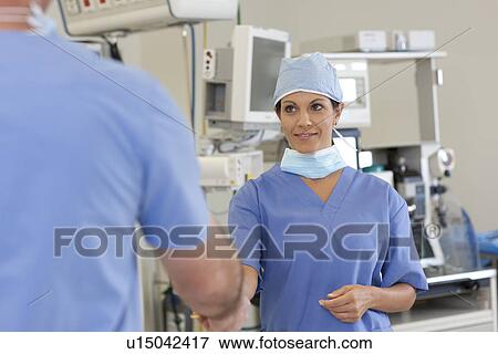 Stock Photo - Surgeons in operating room. Fotosearch