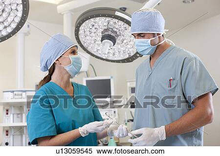 Stock Photography - Surgeons in operating room. Fotosearch