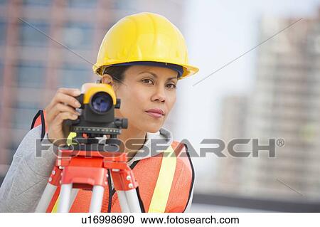 Surveyor using a theodolite instrument View Large Photo Image Stock Image - Surveyor using a theodolite instrument. Fotosearch