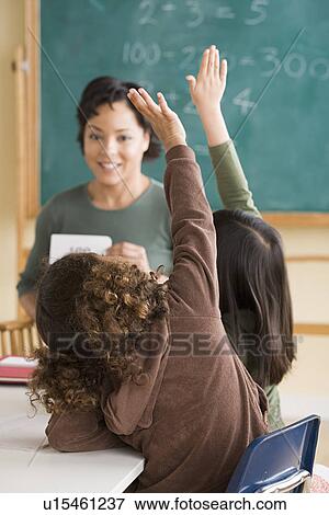 Stock Photo - Teacher and children (6-7) at school. Fotosearch