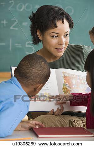 Teacher and children (6-7) at school View Large Photo Image Stock Photo - Teacher and children (6-7) at school. Fotosearch