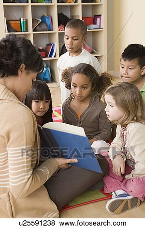 Teacher and children (6-7) at school View Large Photo Image Stock Photo - Teacher and children (6-7) at school. Fotosearch
