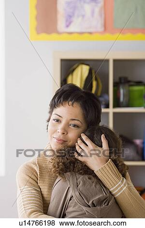 Teacher comforting girl (6-7) View Large Photo Image Stock Photo - Teacher comforting girl (6-7). Fotosearch