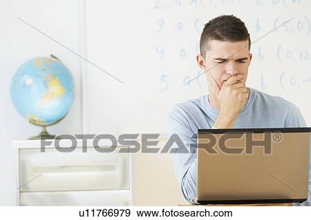 Teenage (16-17) student using laptop View Large Photo Image Stock Photo - Teenage (16-17) student using laptop. Fotosearch