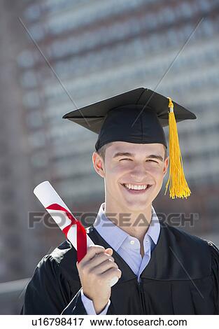 Stock Photo - Teenage boy (16-17) at his graduation ceremony. Fotosearch