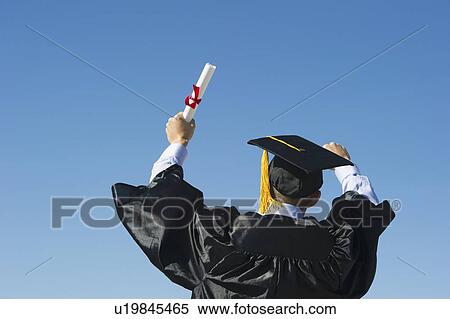 Teenage boy (16-17) at his graduation ceremony View Large Photo Image Stock Photography - Teenage boy (16-17) at his graduation ceremony. Fotosearch
