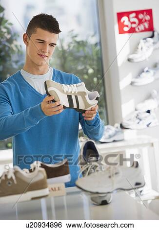 teenage boy (16-17) buying shoes View Large Photo Image Stock Photograph - teenage boy (16-17) buying shoes. Fotosearch