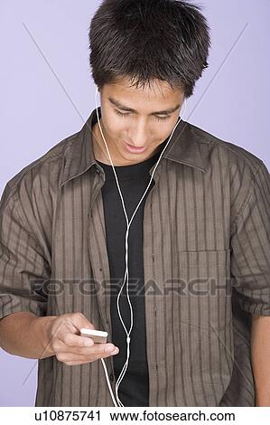 Teenage boy (16-17) listening to mp3 player View Large Photo Image Stock Image - Teenage boy (16-17) listening to mp3 player. Fotosearch