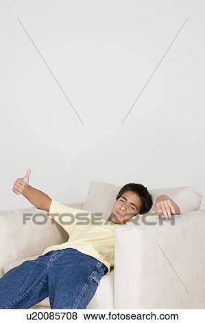 Teenage boy (16-17) relaxing in armchair View Large Photo Image Stock Photo - Teenage boy (16-17) relaxing in armchair. Fotosearch
