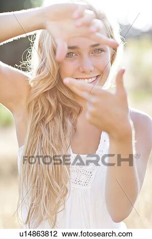 Teenage girl (16-17) displaying finger frame View Large Photo Image Stock Image - Teenage girl (16-17) displaying finger frame. Fotosearch