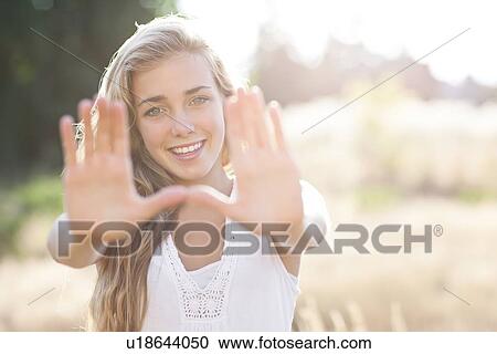 Stock Image - Teenage girl (16-17) displaying stop gesture. Fotosearch