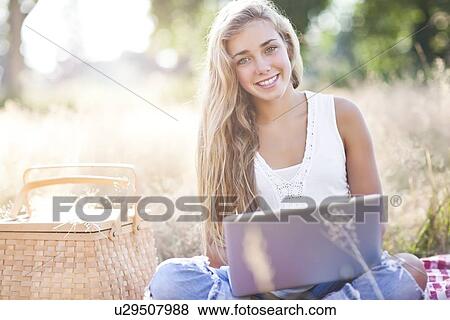 Teenage girl (16-17) posing with laptop outdoors View Large Photo Image Stock Photo - Teenage girl (16-17) posing with laptop outdoors. Fotosearch