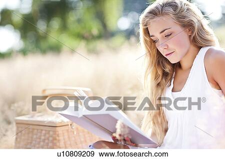 Teenage girl (16-17) reading book outdoors View Large Photo Image Stock Photo - Teenage girl (16-17) reading book outdoors. Fotosearch