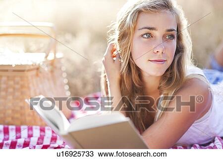 Teenage girl (16-17) taking break from reading book outdoors View Large Photo Image Stock Image - Teenage girl (16-17) taking break from reading book outdoors. Fotosearch