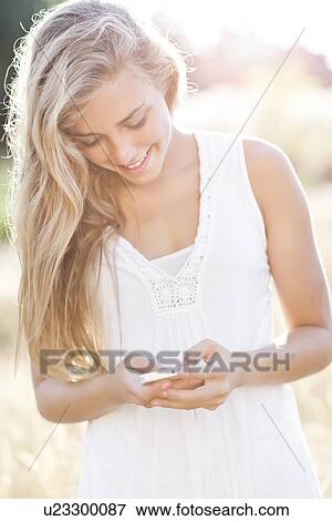 Teenage girl (16-17) text messaging outdoors View Large Photo Image Stock Photo - Teenage girl (16-17) text messaging outdoors. Fotosearch