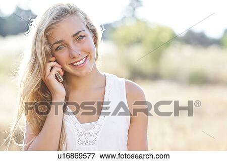 Teenage girl (16-17) using mobile phone outdoors View Large Photo Image Stock Photo - Teenage girl (16-17) using mobile phone outdoors. Fotosearch