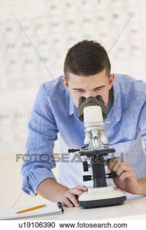 Teenage student (16-17) looking through microscope View Large Photo Image Stock Image - Teenage student (16-17) looking through microscope. Fotosearch
